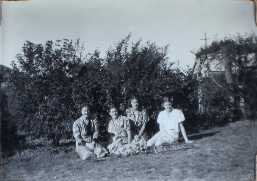 Four female students sitting on the lawn