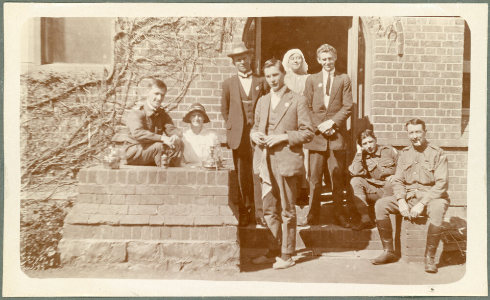 Group of six men and two women outside Booloominbah
