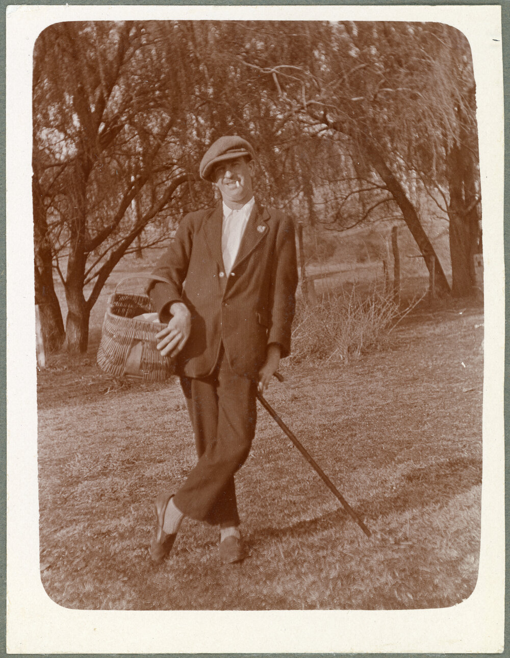 Man with walking cane and picnic basket