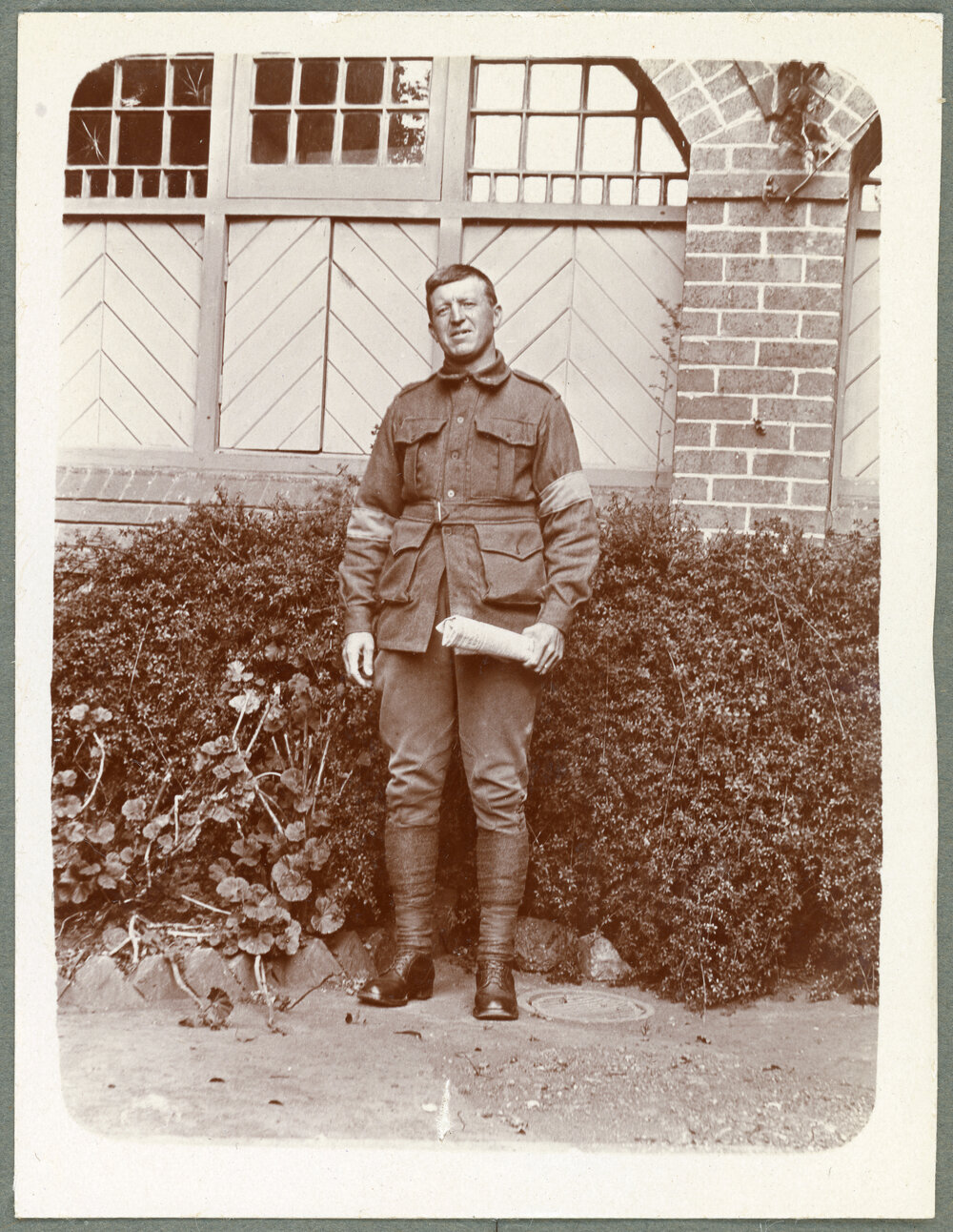 Soldier holding rolled up newspaper