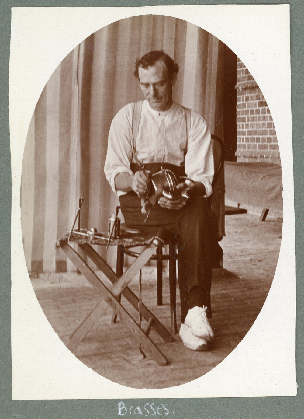 Man cleaning brass item