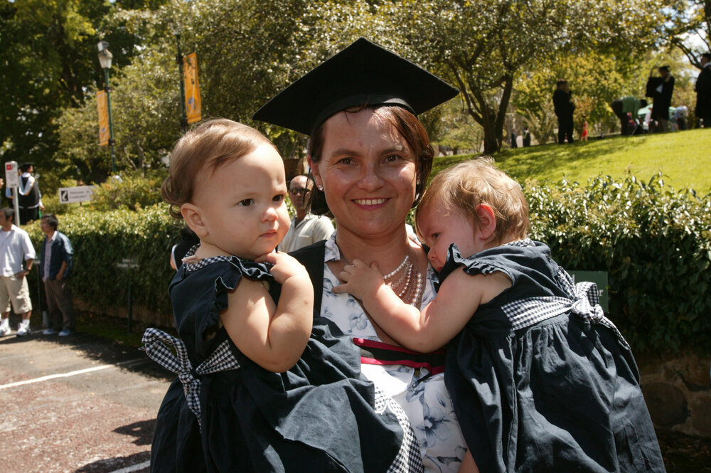 Unidentified graduate with two children, TRACKS Graduation Ceremony, UNE, 2005