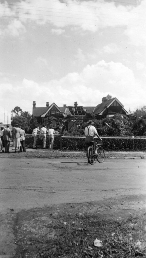 People viewing tornado damage to a house, Armidale, 1954