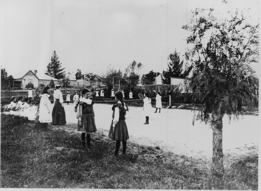 Pupils on and around tennis court at the Public School, c. 1900