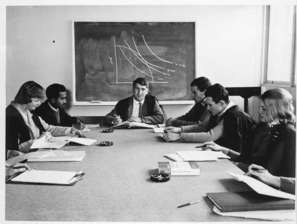 Tutorial group around table with Prof. Warren Musgrave