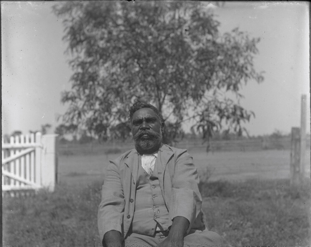 "Dag" [Aboriginal man sitting outside]