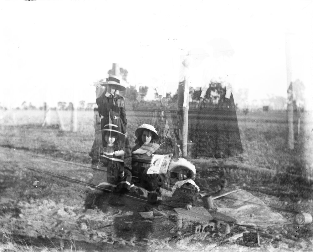 Double exposed, children in hats and railway tracks