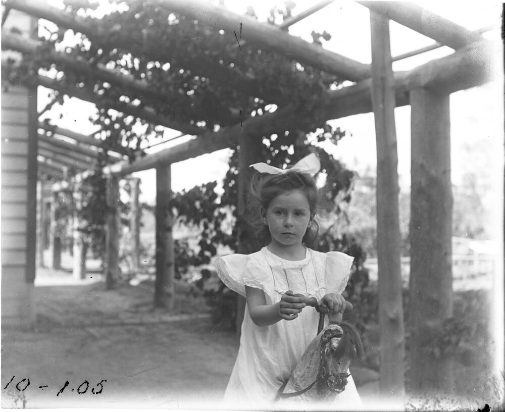 Girl on rocking horse, [1905]