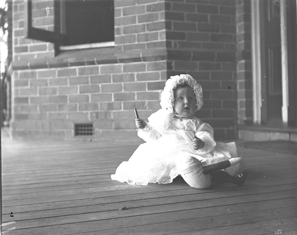 Baby sitting on a veranda