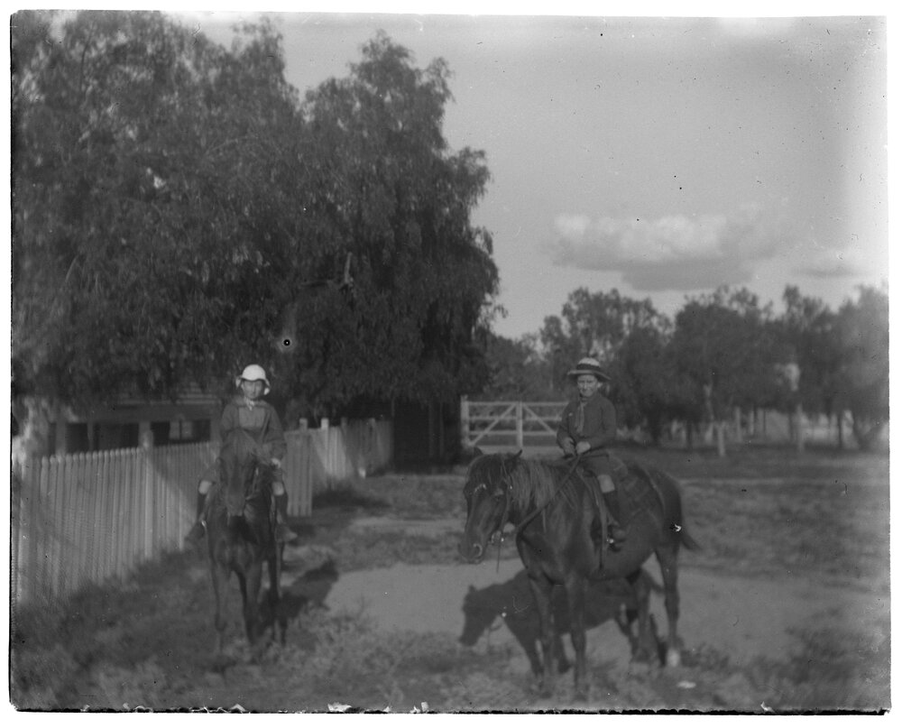 Two children riding horses
