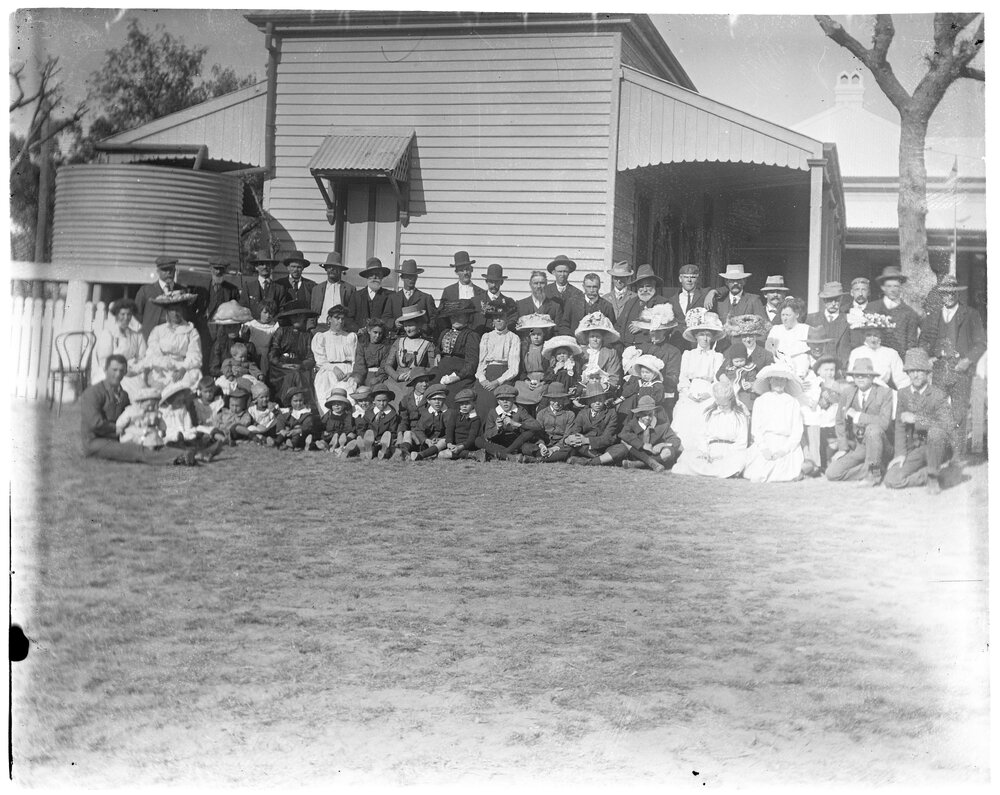 Large group photo outside a house