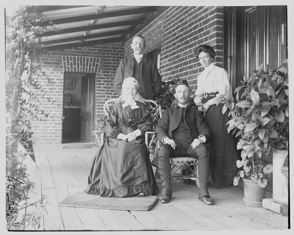 Group portrait of two men and two women on a verandah, 1907
