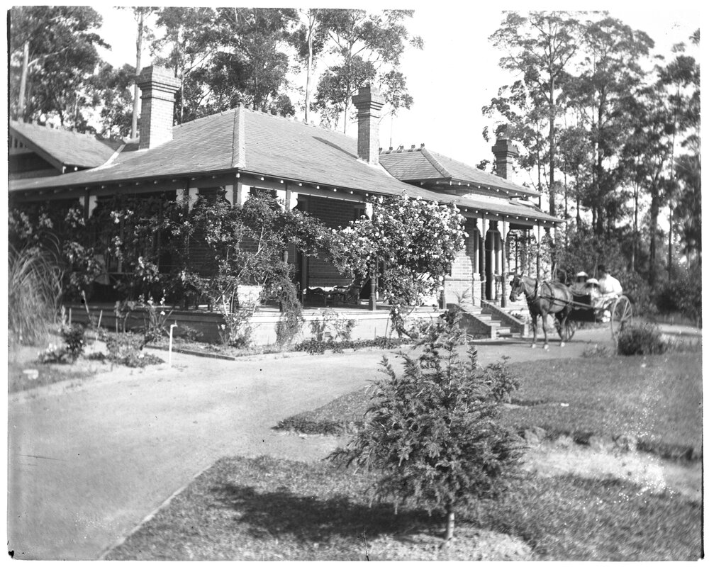 Exterior view of a house with horse and carriage