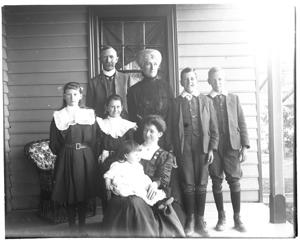 D. M. Cameron with family group on a verandah