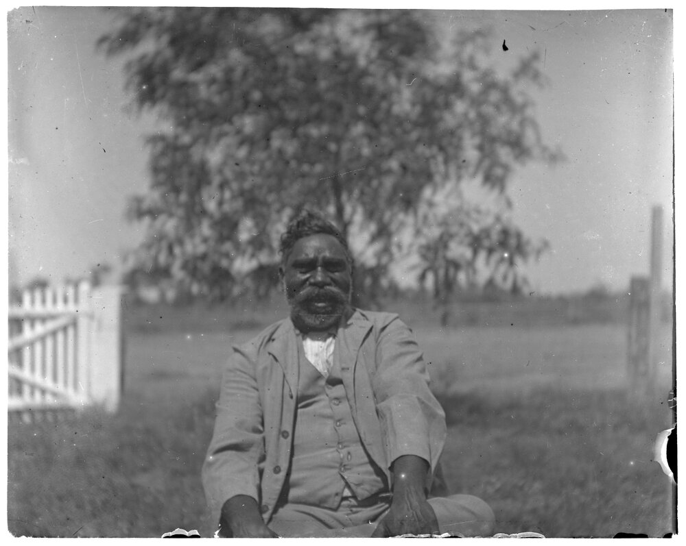 Aboriginal man sitting outside
