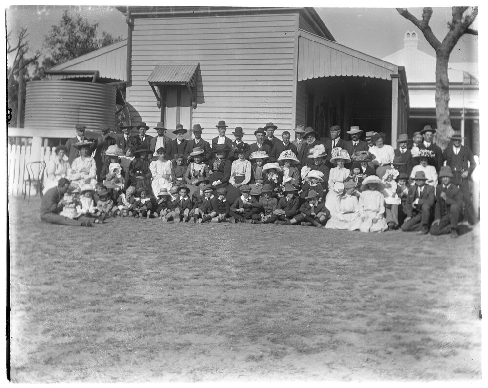 Large group portrait outside a house