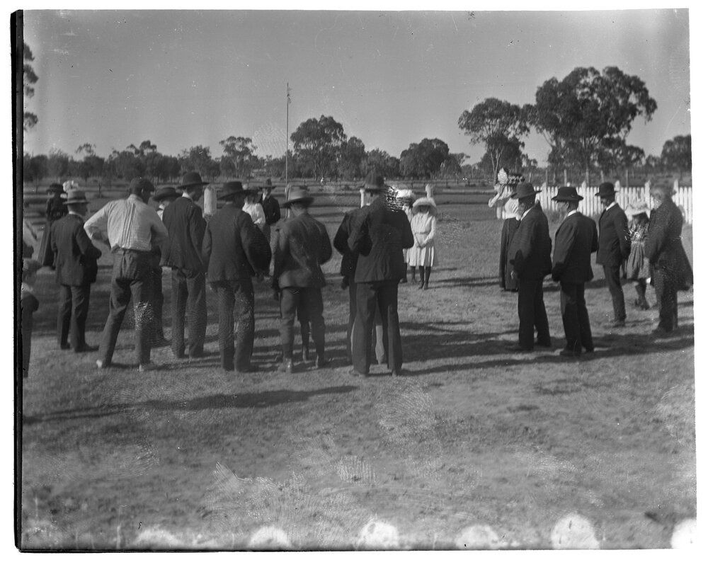 Gathered group of men, women and children