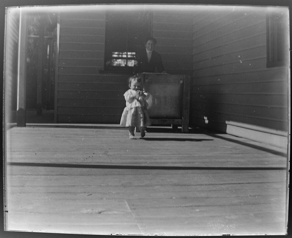 Woman and child on a verandah