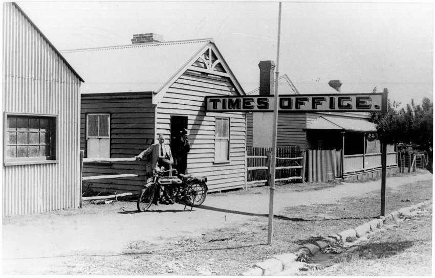Uralla Times Office, Roy S. Vincent in dust coat near his bike