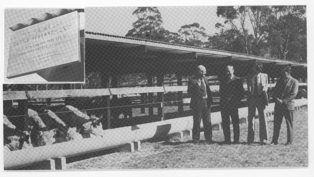 Four men standing in front of the P.A. Wright Cattle Research Facility