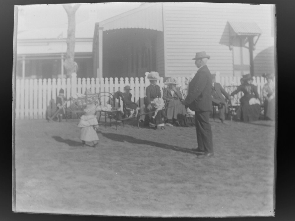 Child on a lead, at an outdoor gathering