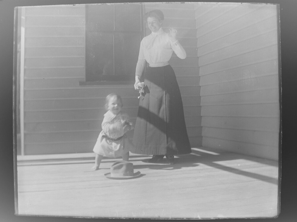 Woman and child playing on a verandah
