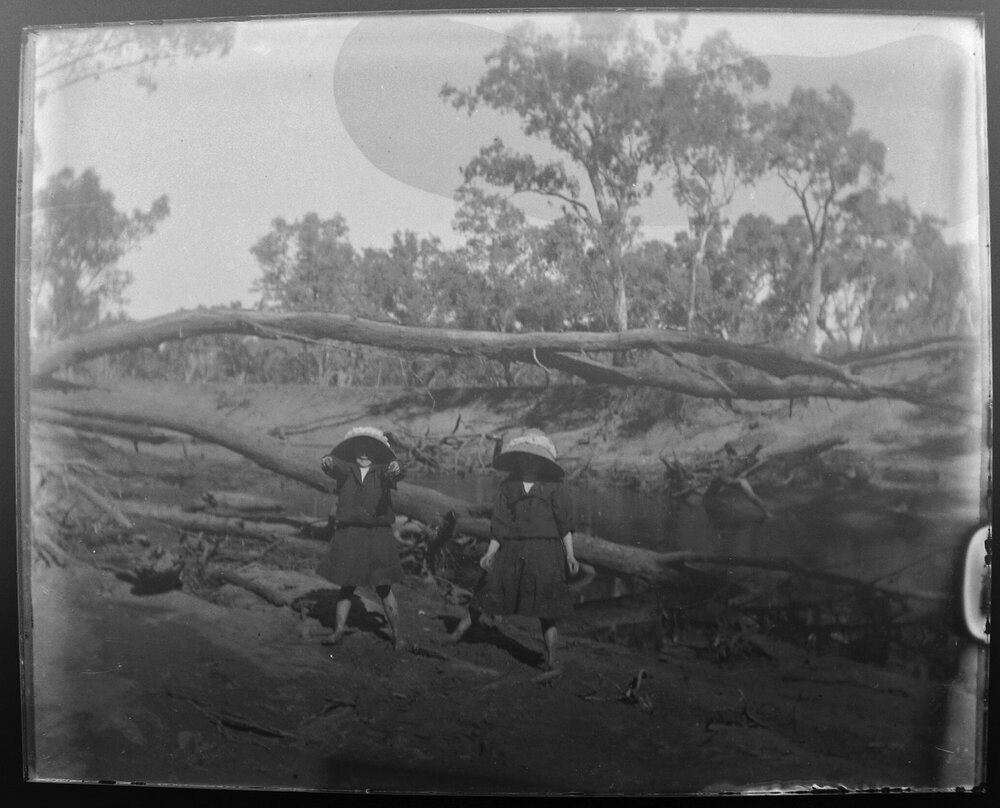 Maggie and Georgie in bed of River Walla, 1906
