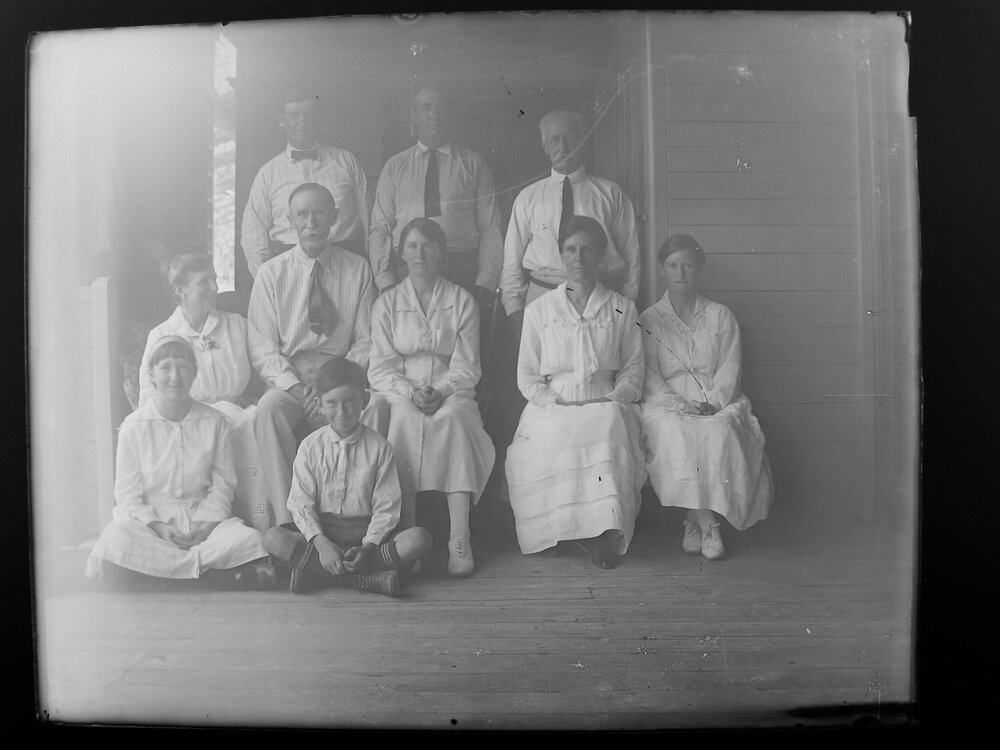 Posed group portrait of four men, four women, a girl and a boy
