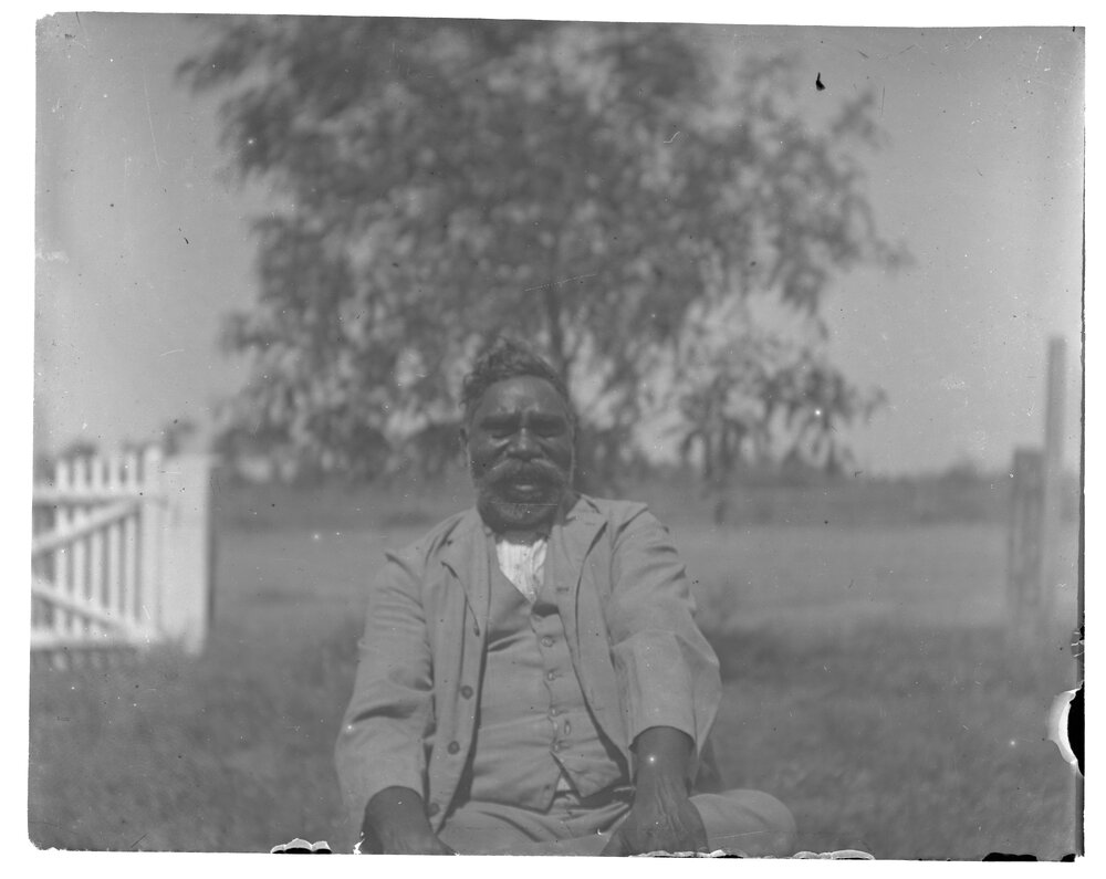 Aboriginal man sitting outside