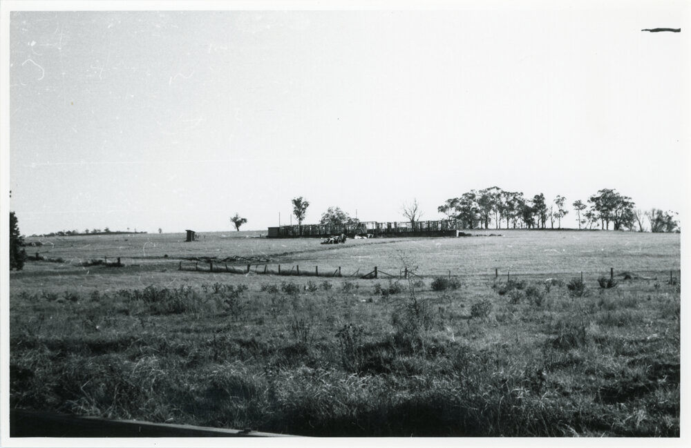 View across a field towards the Wright College construction site, 1958