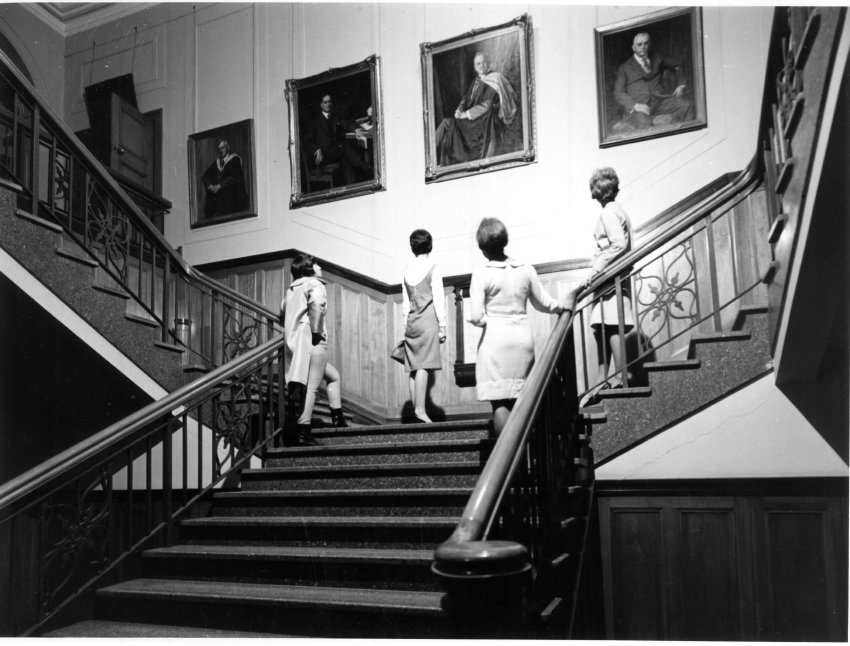 Armidale Teachers' College students admiring portraits in the College foyer, c.1965