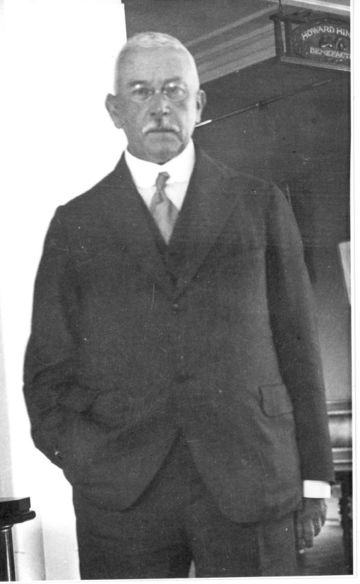 Howard Hinton standing beside a sign saying Howard Hinton Benefactor