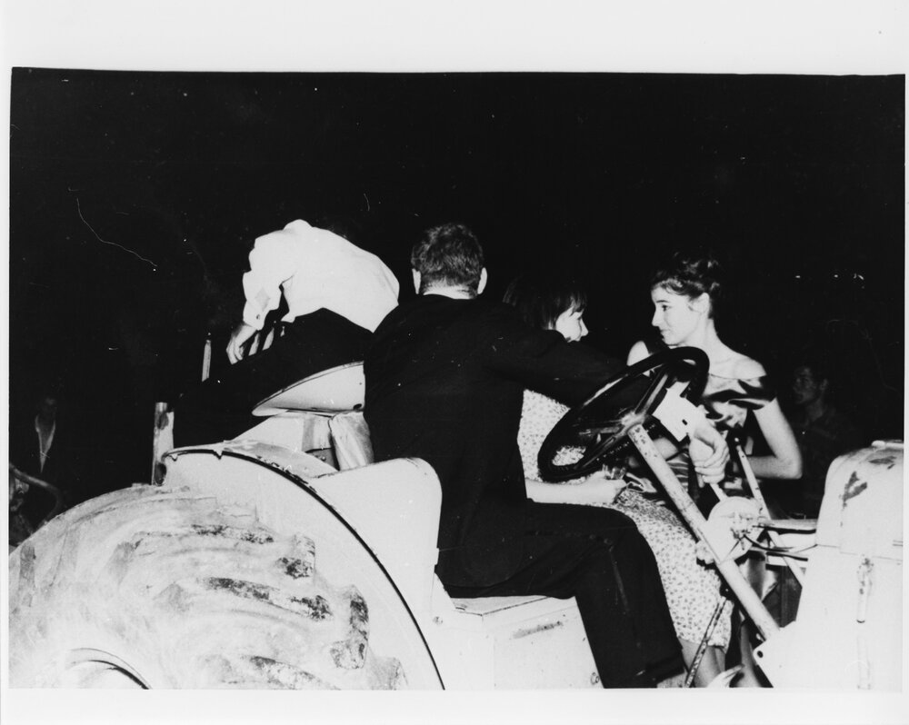 Wright College students on a tractor dressed in formal wear