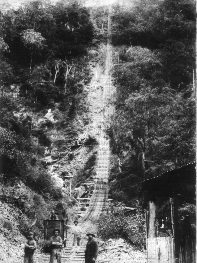 West Sunlight Tramway, Metz. Group of miners and ore cart at bottom of Baker's Creek Gorge.