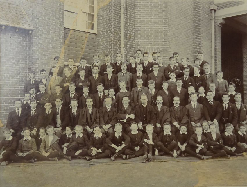 Group of pupils and staff outside the Armidale School
