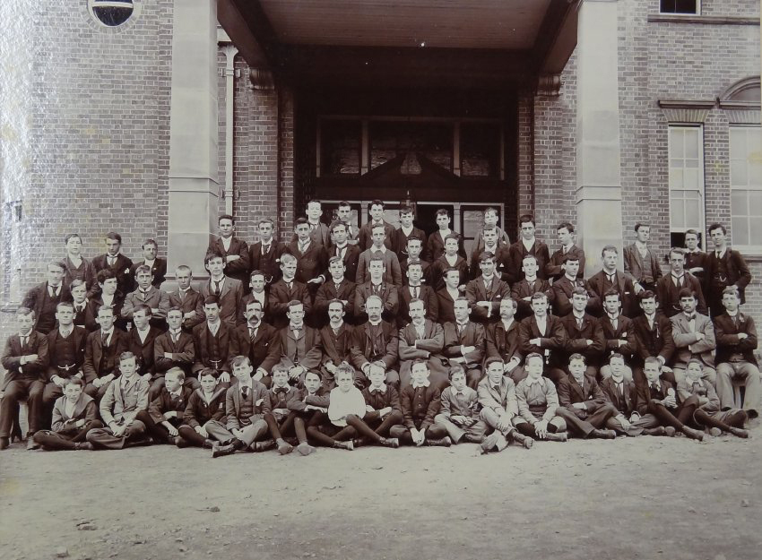 Group of pupils and staff outside the Armidale School