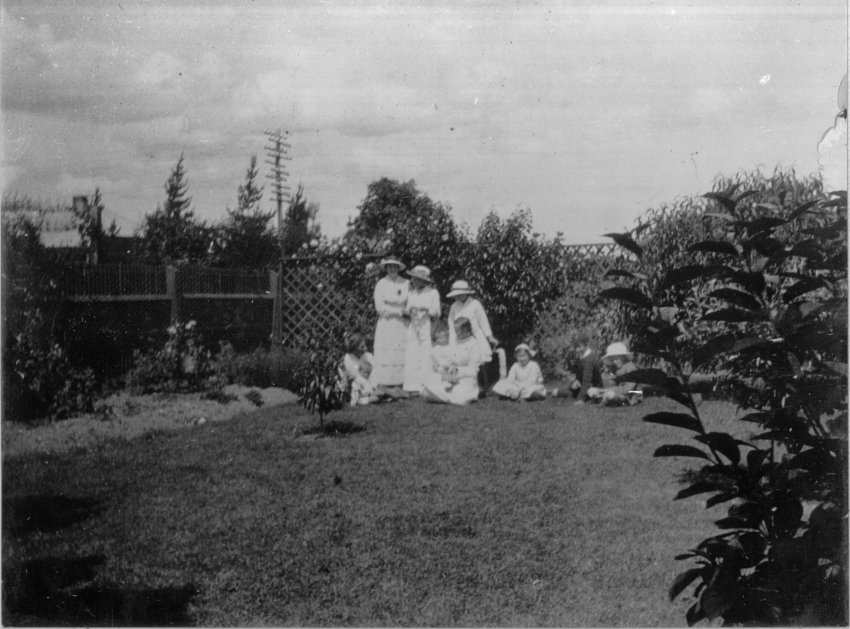 Photo of a group of women and children in a garden