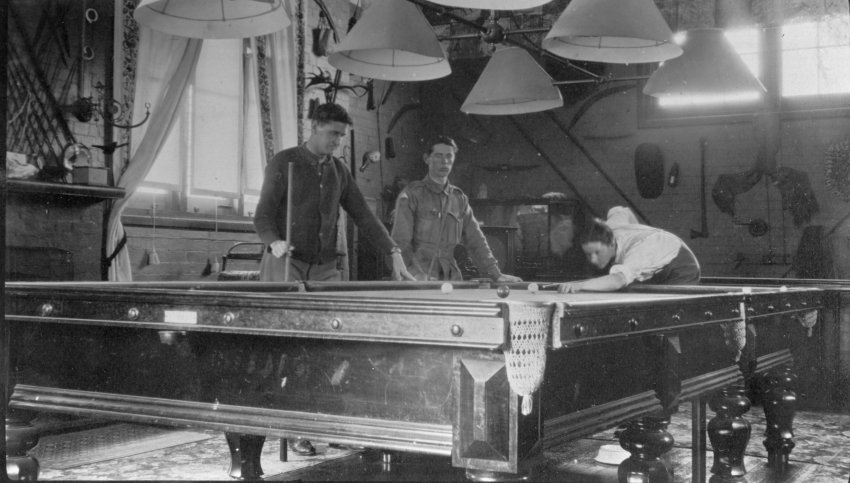 Three men playing billards