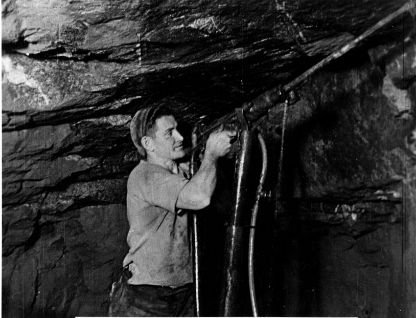 Andy Boundy drilling on the wall of the Damifino Mine with an impact jack hammer, c.1948
