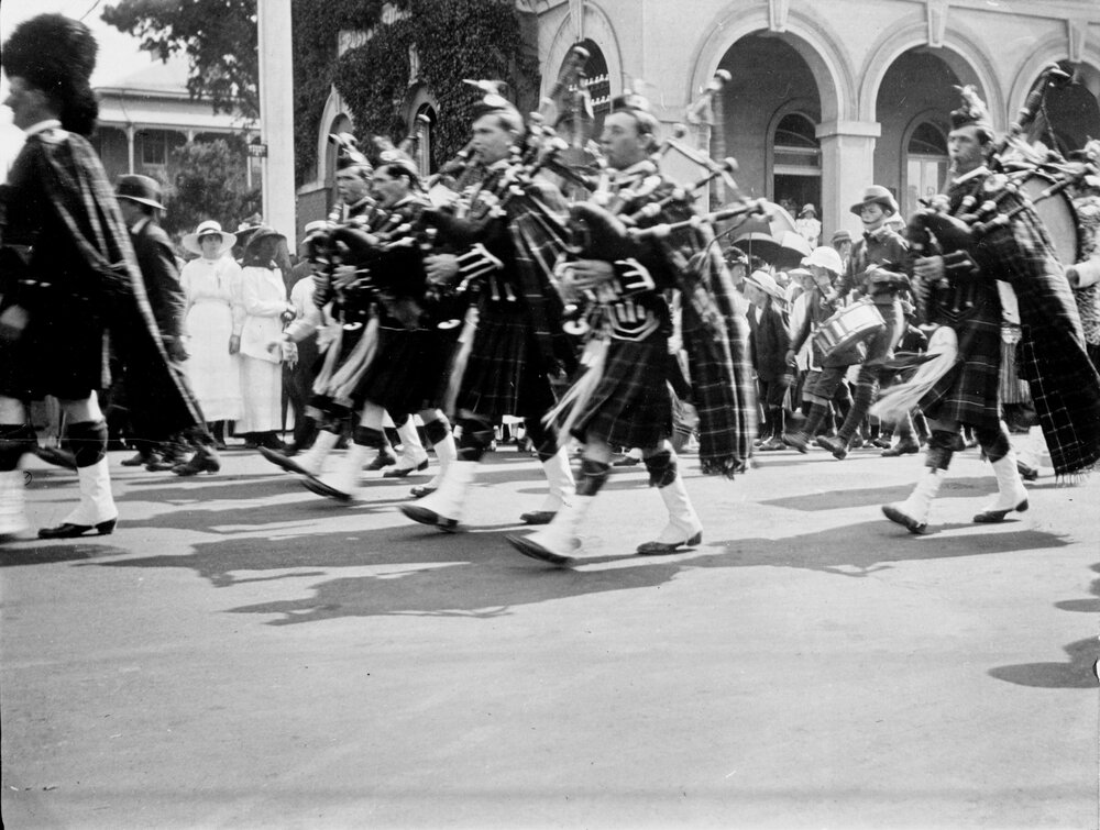 Pipe band marching past Post Office, Armidale c. 1910