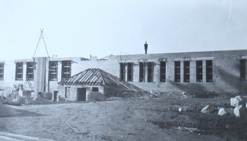 Man standing on top of a partially completed building, ATC
