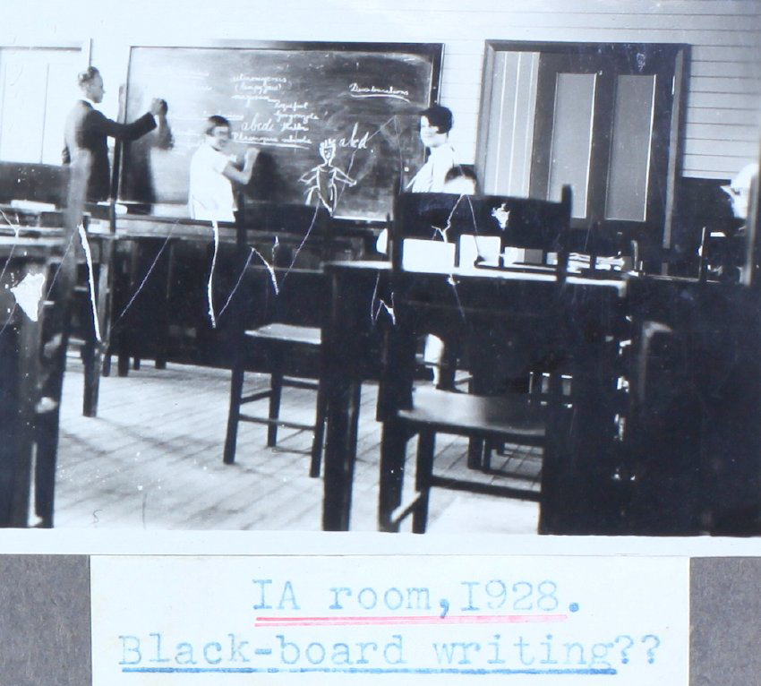 Students and a teacher at the blackboard in room 1A, 1928