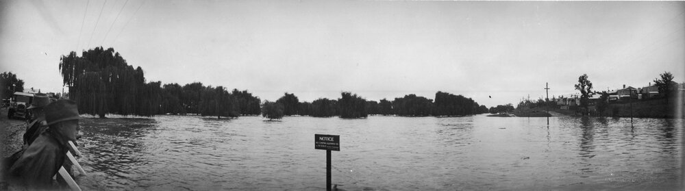 Flood, looking along Creek from Stephens Bridge with notice "No Camping Allowed on this Reserve", 1928