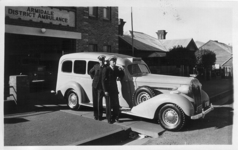Ambulance and two officers outside Armidale District Station, Rusden Street, Armidale