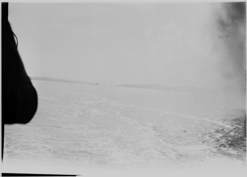 Unidentified stretch of sea with a coast in the distance