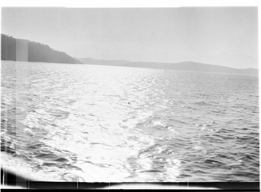 Unidentified stretch of sea with a coast in the distance