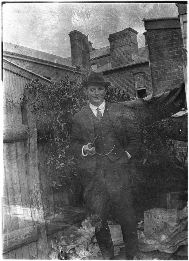 Unidentified man at the rear of Mallam's Pharmacy, Beardy Street, Armidale