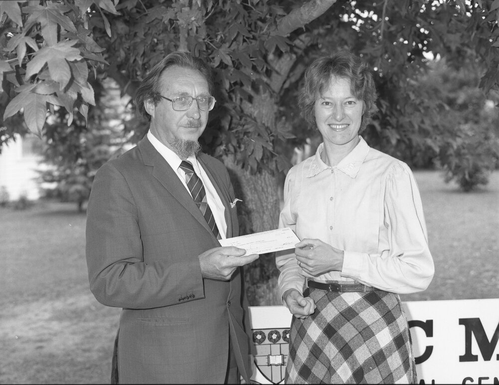 Professor J. Nalson presenting a cheque to Dr Cunningham for M.J. Lewis (MS sufferer), 1996