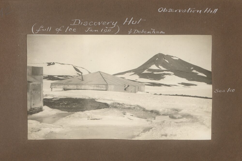 Discovery hut with Observation Hill behind, 1911