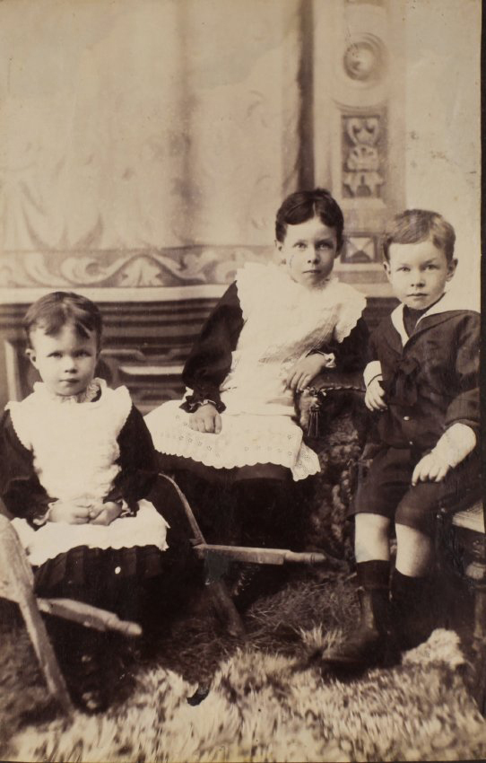 Three unidentified children seated